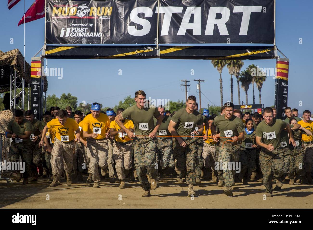 Marines and sailors run during the 2018 Mud Run Commanding General’s Cup Team Competition on Marine Corps Base Camp Pendleton, Calif., June 8, 2018. The race stretched over 10-kilometers around Lake O’Neill on MCB Camp Pendleton. Over 2,000 Marines from numerous units around California and neighboring states participated in the challenge. Stock Photo
