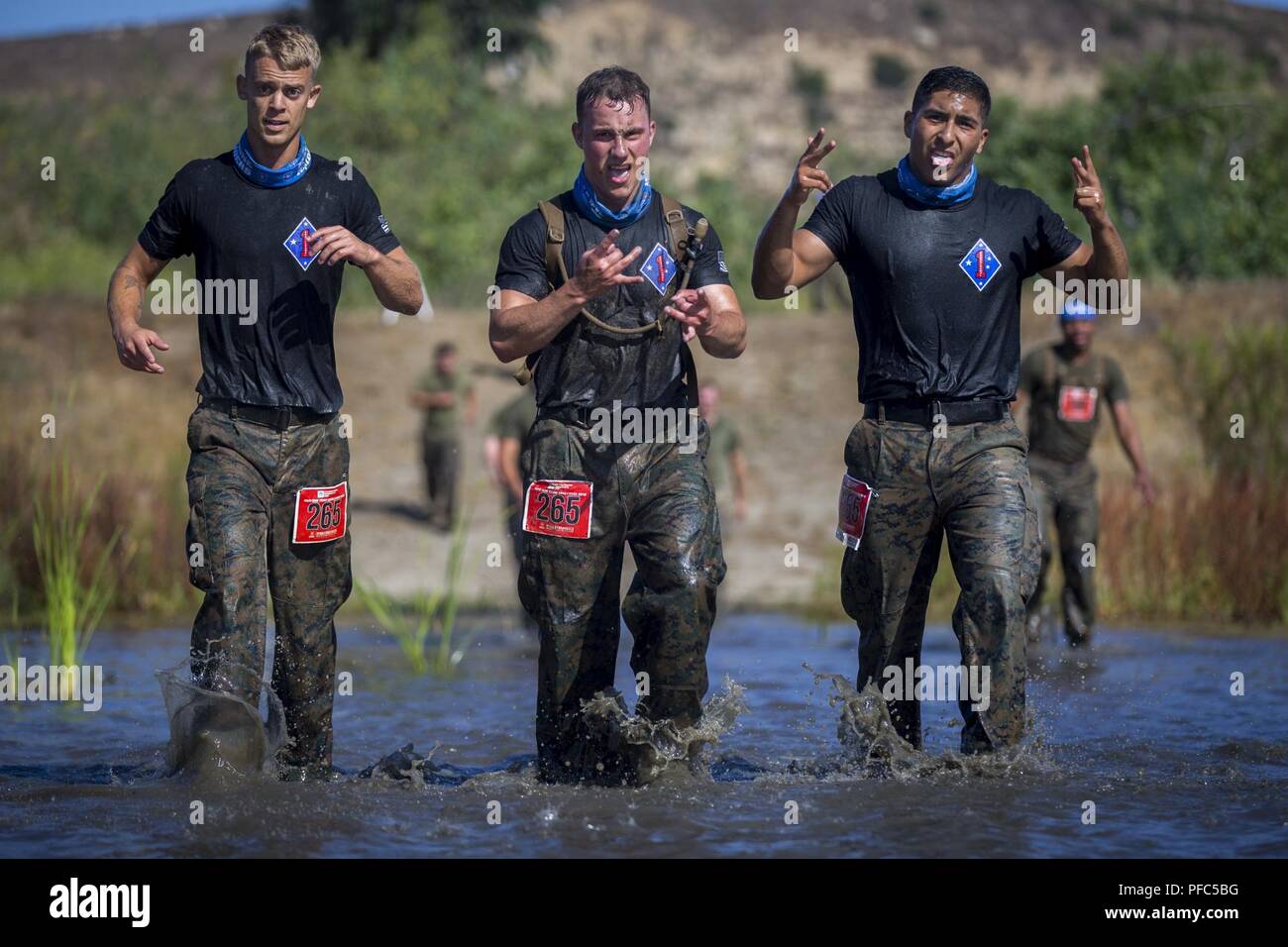Marines run through the,“Chosin Reservoir”portion of the 2018 Mud Run Commanding General’s Cup Team Competition, on Marine Corps Base Camp Pendleton, Calif., June 8, 2018. The race stretched over 10-kilometers around Lake O’Neill on MCB Camp Pendleton. Over 2,000 Marines from numerous units around California and neighboring states participated in the challenge. Stock Photo