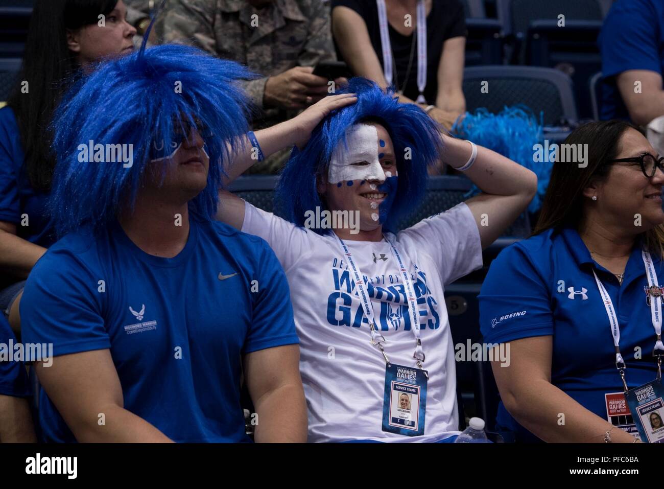 Team Air Force fans cheer on Team Air Force during the DoD Warrior Games sitting volleyball finals, June 8, 2018, at the U.S. Air Force Academy in Colorado Springs, Colorado. The Warrior Games are an annual event, established in 2010, to introduce wounded, ill and injured service members to adaptive sports as a way to enhance their recovery and rehabilitation. Stock Photo