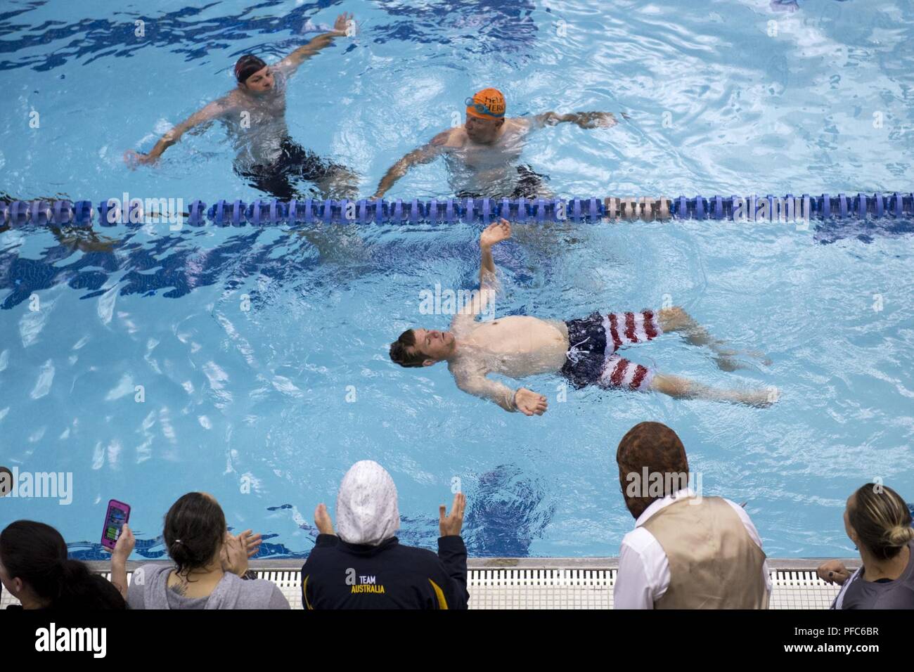 Team SOCOM veteran Capt. James Howard competes in the 2018 DoD Warrior Games swimming competition surrounded by supporters and competitors in the race at the Air Force Academy in Colorado Springs, Colo. June 8, 2018. Stock Photo