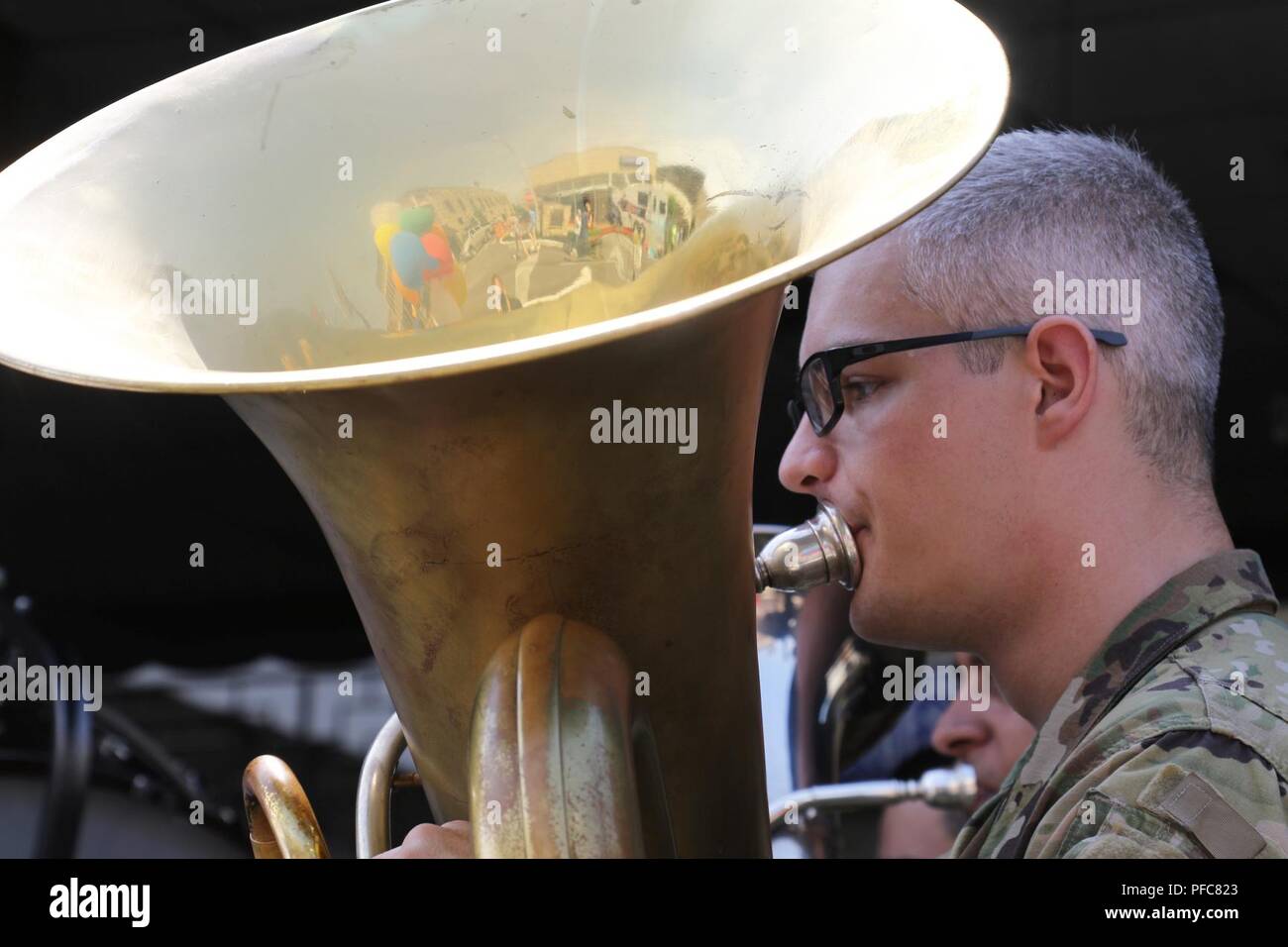 A tuba player with the 106th Army Band plays for the crowd at the