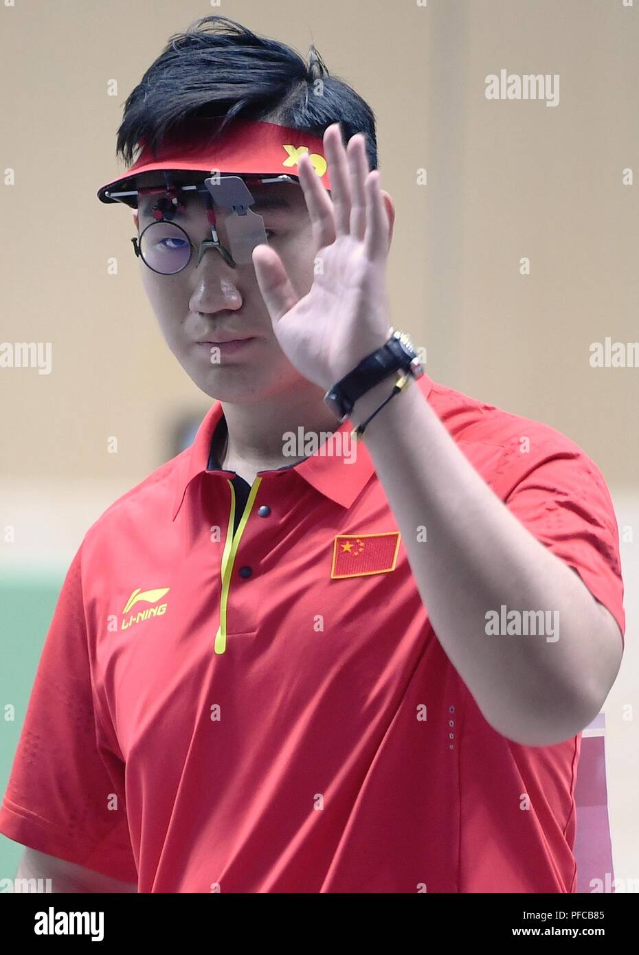 Palembang. 21st Aug, 2018. Wu Jiayu of China gestures during the men's 10m Air Pistol final at the 18th Asian Games in Palembang, Indonesia on Aug. 21, 2018. Wu got the 4th place. Credit: Wang Shen/Xinhua/Alamy Live News Stock Photo