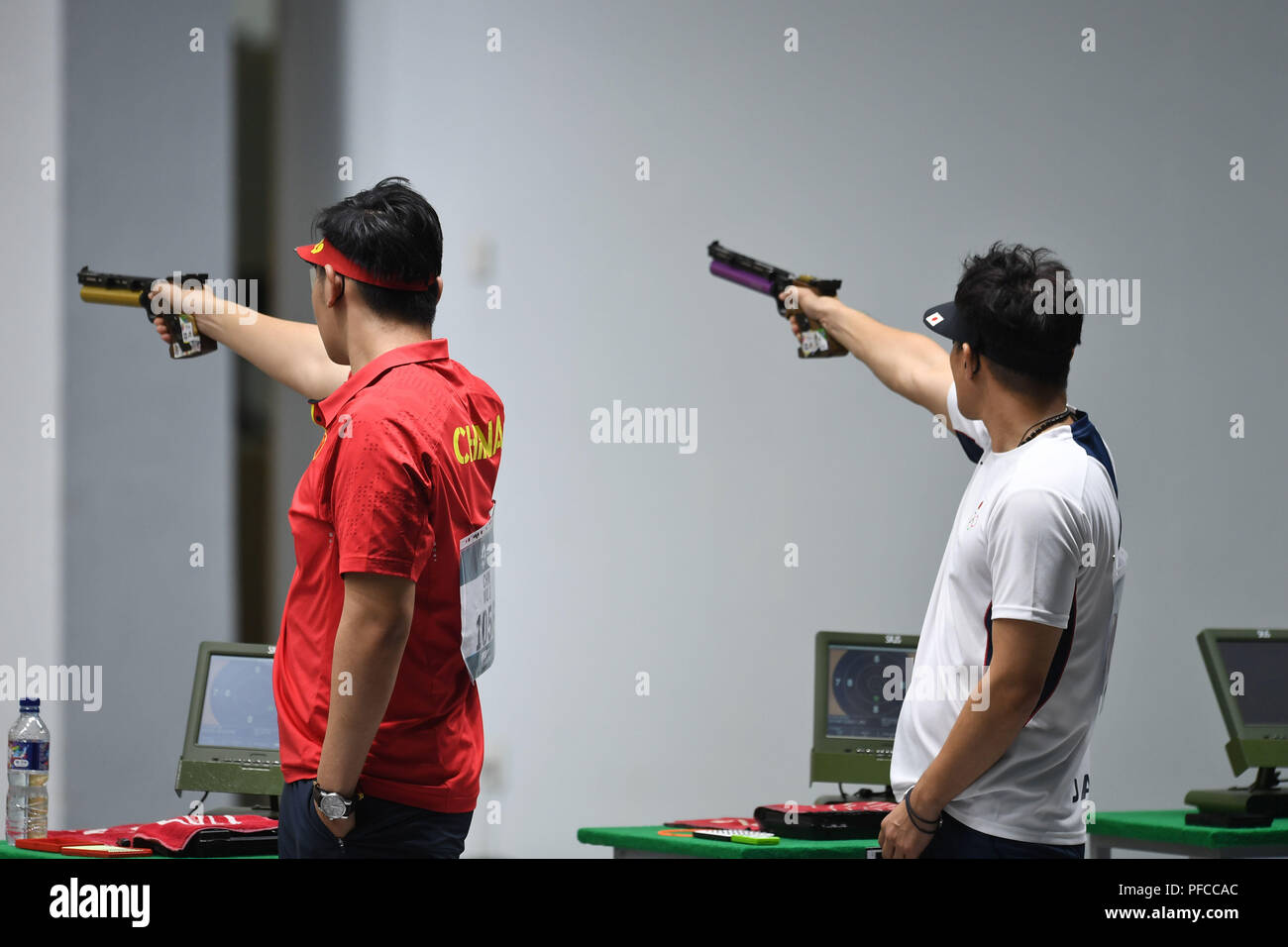 Palembang. 21st Aug, 2018. Matsuda Tomoyuki (R) of Japan and Wu Jiayu of China compete during the men's 10m Air Pistol final at the 18th Asian Games in Palembang, Indonesia on Aug. 21, 2018. Matsuda Tomoyuki won the silver medal and Wu Jiayu got the 4th place. Credit: Liu Ailun/Xinhua/Alamy Live News Stock Photo