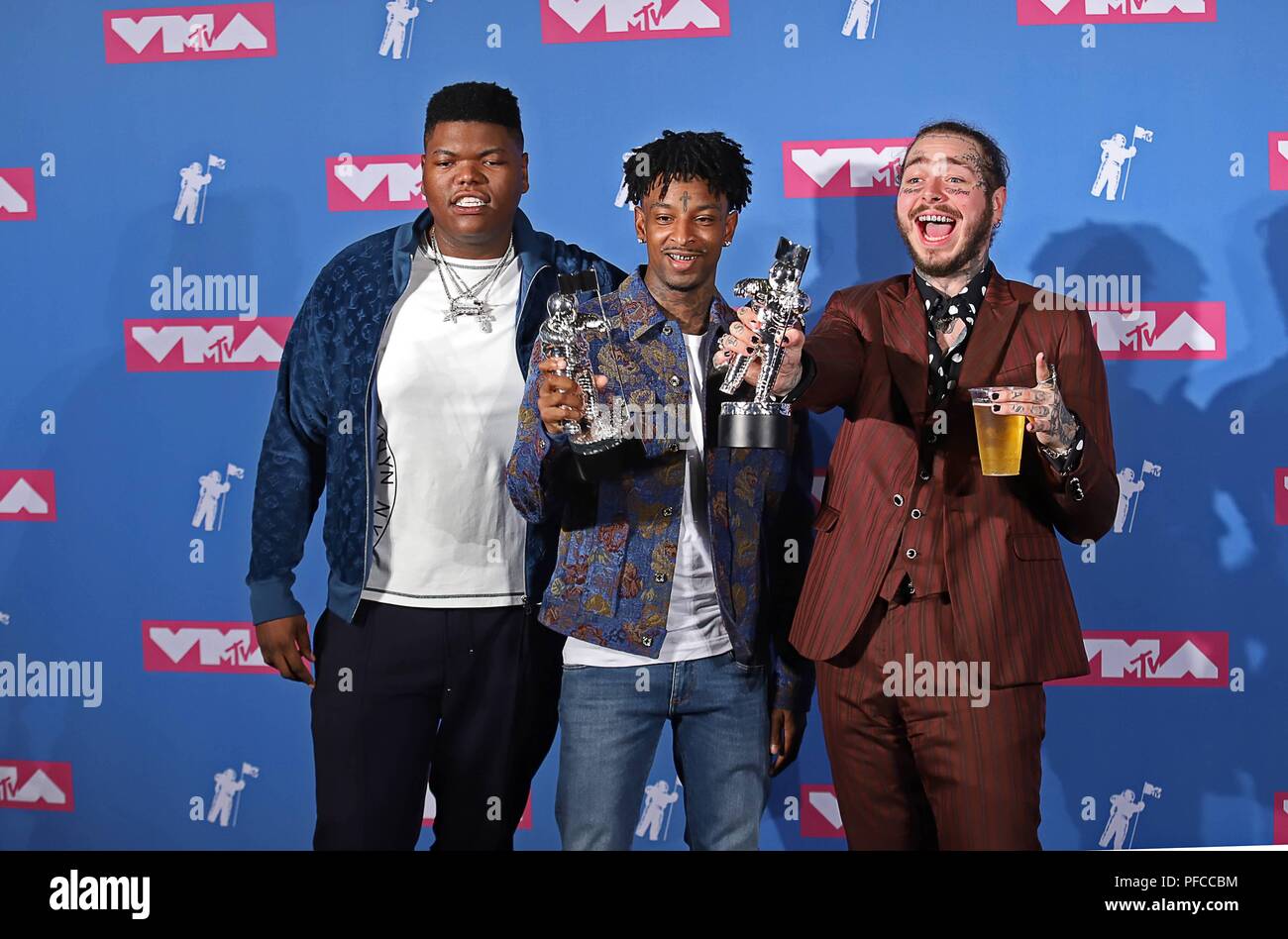 Inglewood, United States Of America. 20th Aug, 2018. 21 Savage (c) and Post  Malone (r) pose with the Song of the Year award in the press room of the  2018 MTV Video