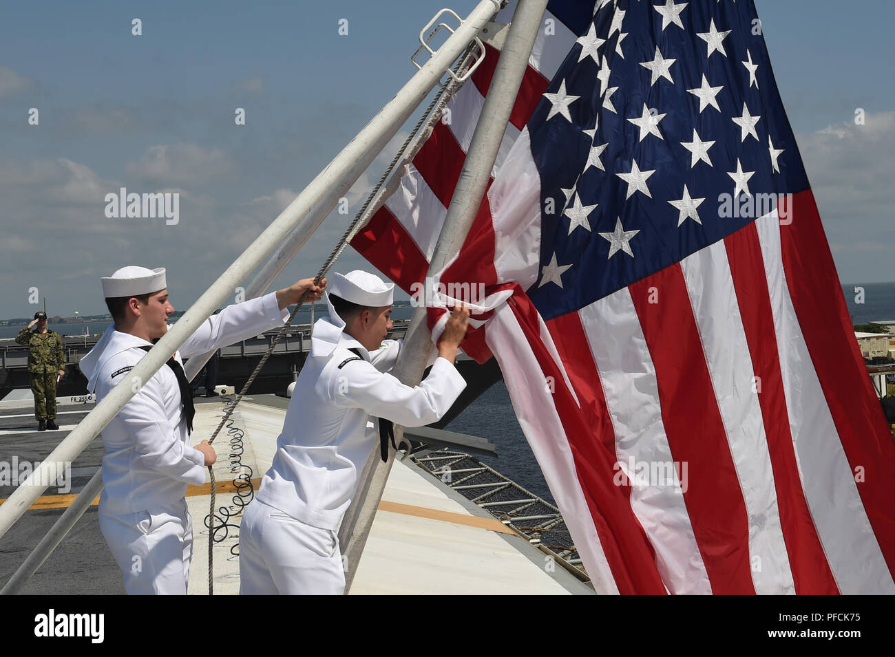 Norfolk, Va, USA. 19th Aug, 2018. NORFOLK (Aug. 19, 2018) Aviation Ordnanceman 3rd Class Joseph Rodriguez, right, and Aviation Ordnanceman Airman Kevin Pawlowski lower the national ensign on the flight deck of the Nimitz-class aircraft carrier USS Abraham Lincoln (CVN 72). Abraham Lincoln is currently underway conducting carrier qualifications in preparation for an upcoming deployment. (U.S. Navy photo by Mass Communication Specialist 2nd Class Mark Andrew Hays/Released) 180819-N-JX484-008 US Navy via globallookpress.com Credit: Us Navy/Russian Look/ZUMA Wire/Alamy Live News Stock Photo
