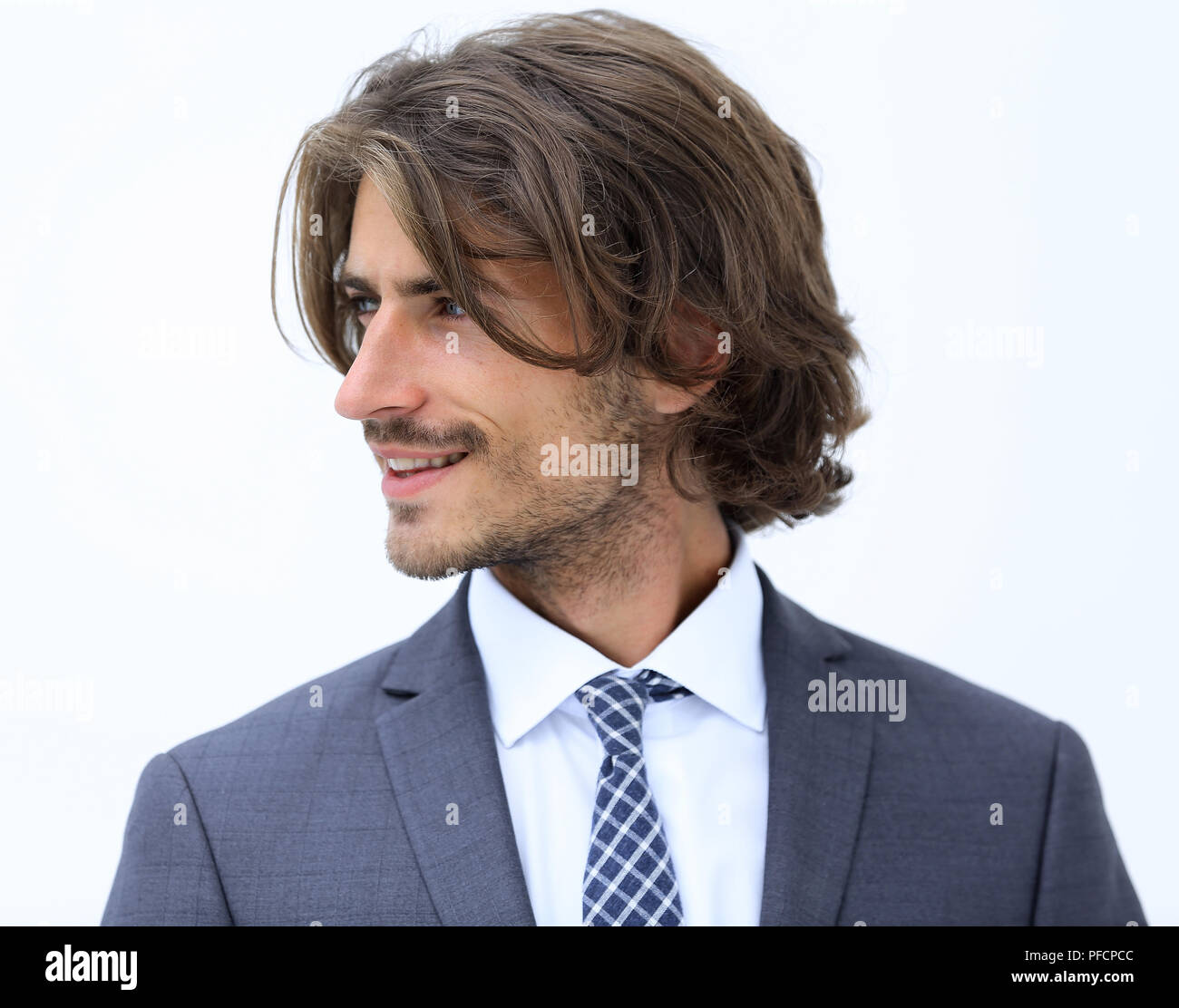 Handsome man in stylish clothes is looking away and smiling Stock Photo