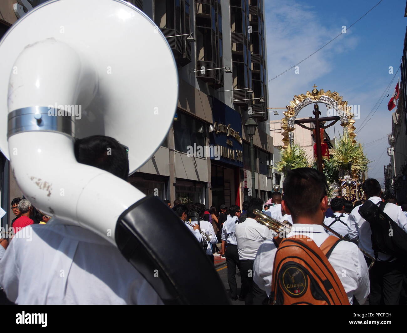 Devotees musicians, playing the sousaphone, following a religious procession on Palm Sunday of the 2018 Holy Week Stock Photo