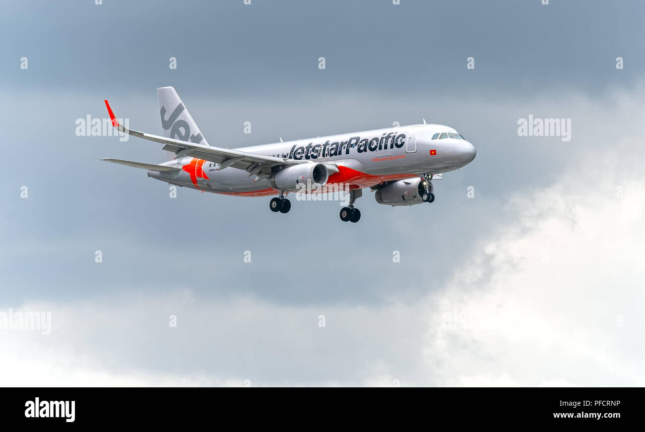 Passenger aircraft airbus A320 of Jetstar Pacific fly in sky prepare to landing at Tan Son Nhat International Airport Stock Photo