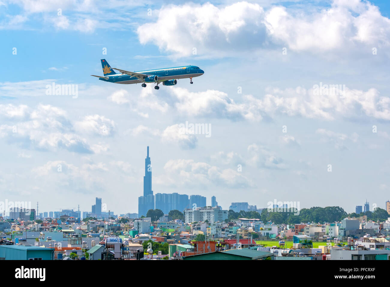 Aibus a321 passenger aircraft of Vietnam airline fly over urban areas preparing to land at Tan Son Nhat International Airport Stock Photo