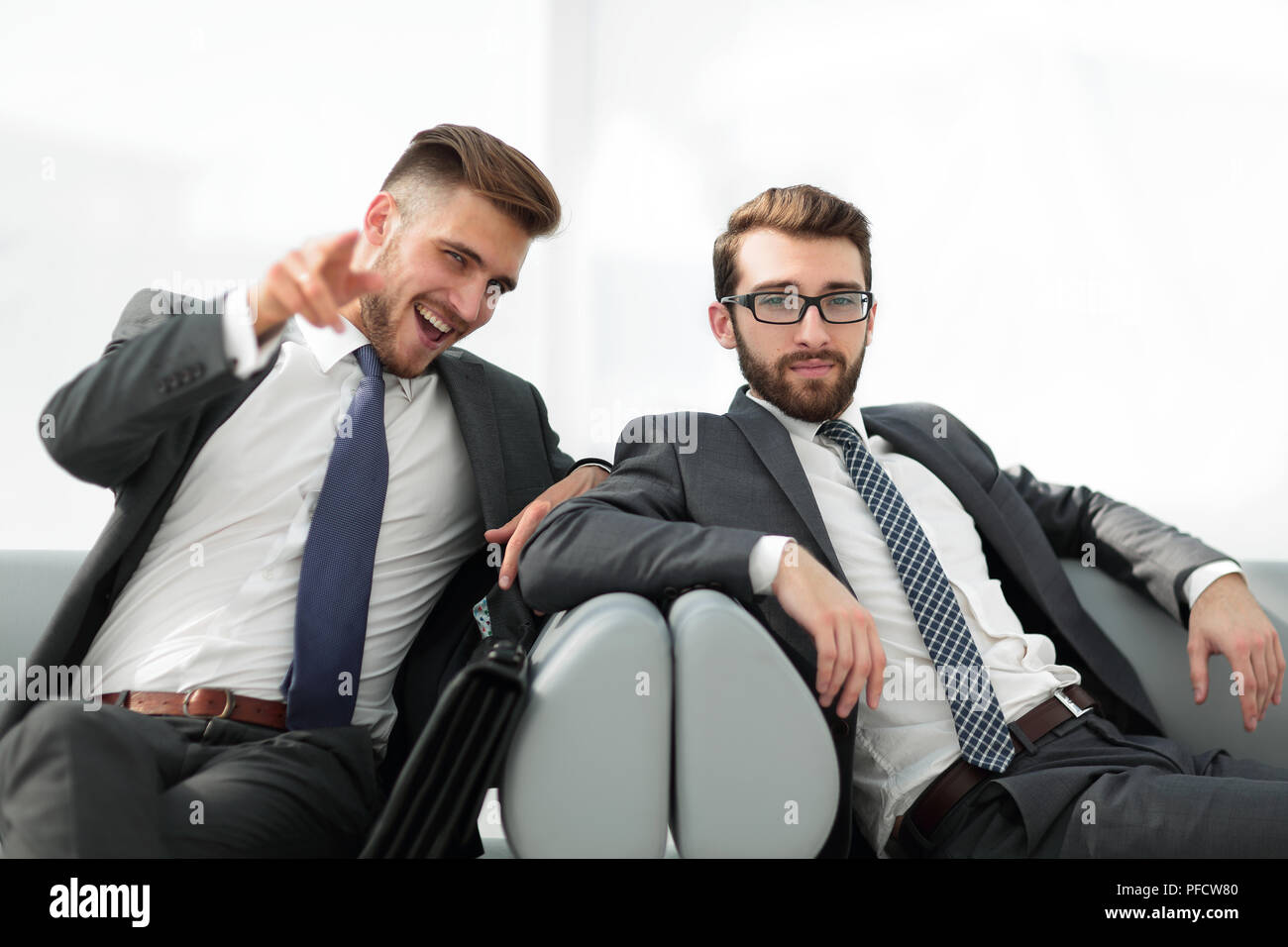 two successful business people sitting in the lobby of the office Stock ...