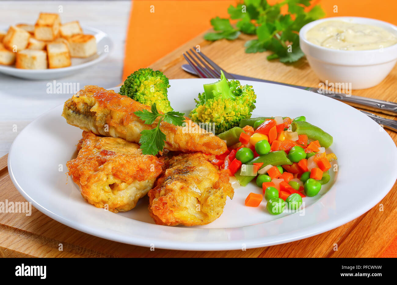 deep fried perch fillets served with mix of steam cooked vegetables on