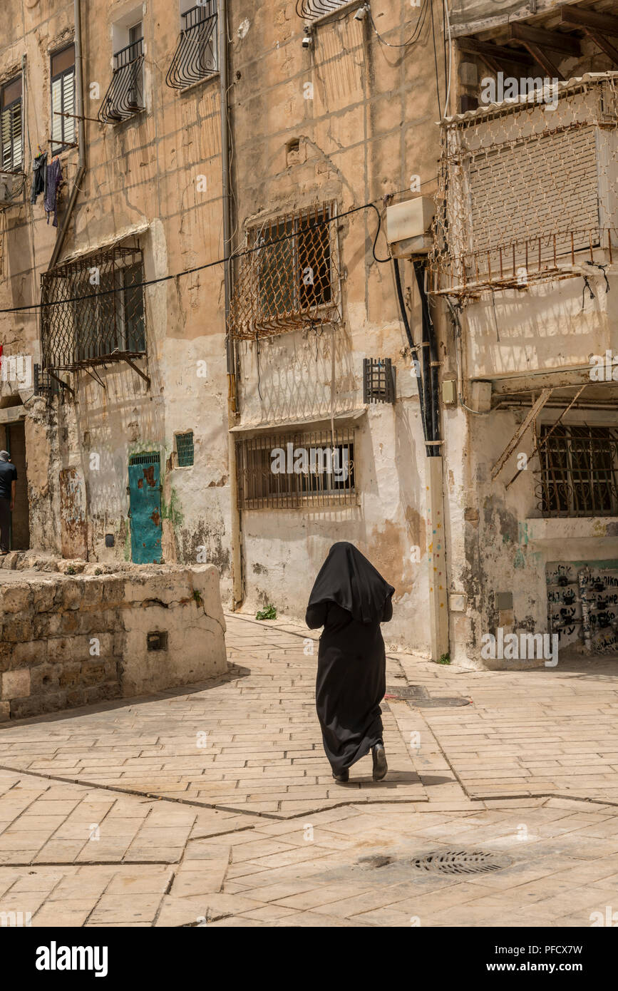 Acre, Israel - May 10, 2018 : Muslim woman walking in old Acre Stock Photo