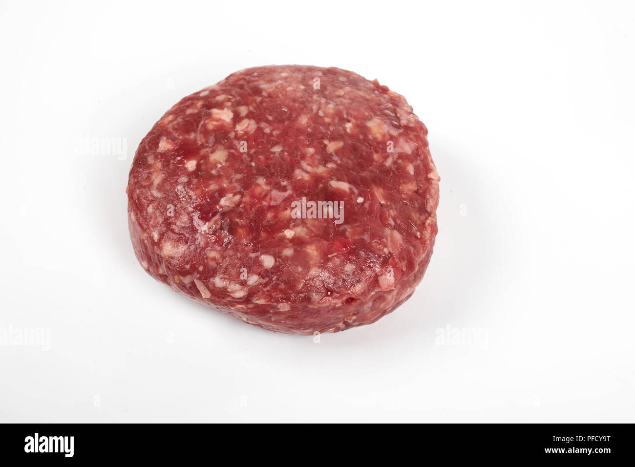 Raw fresh large beef burger or cutlets isolated on white background Stock Photo