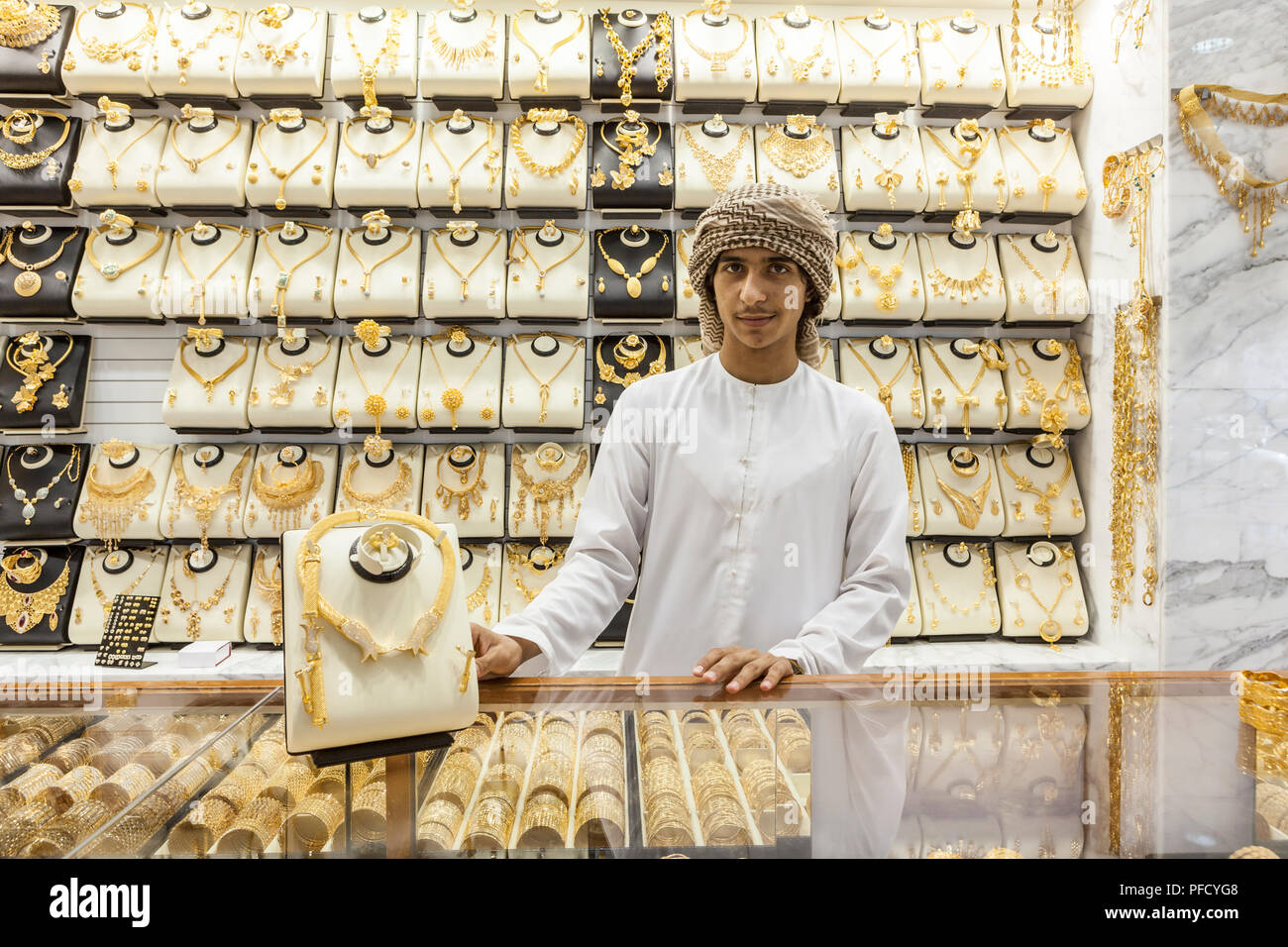 Salesman in traditional Arab dress in Gold Souk in Dubai, UAE Stock ...