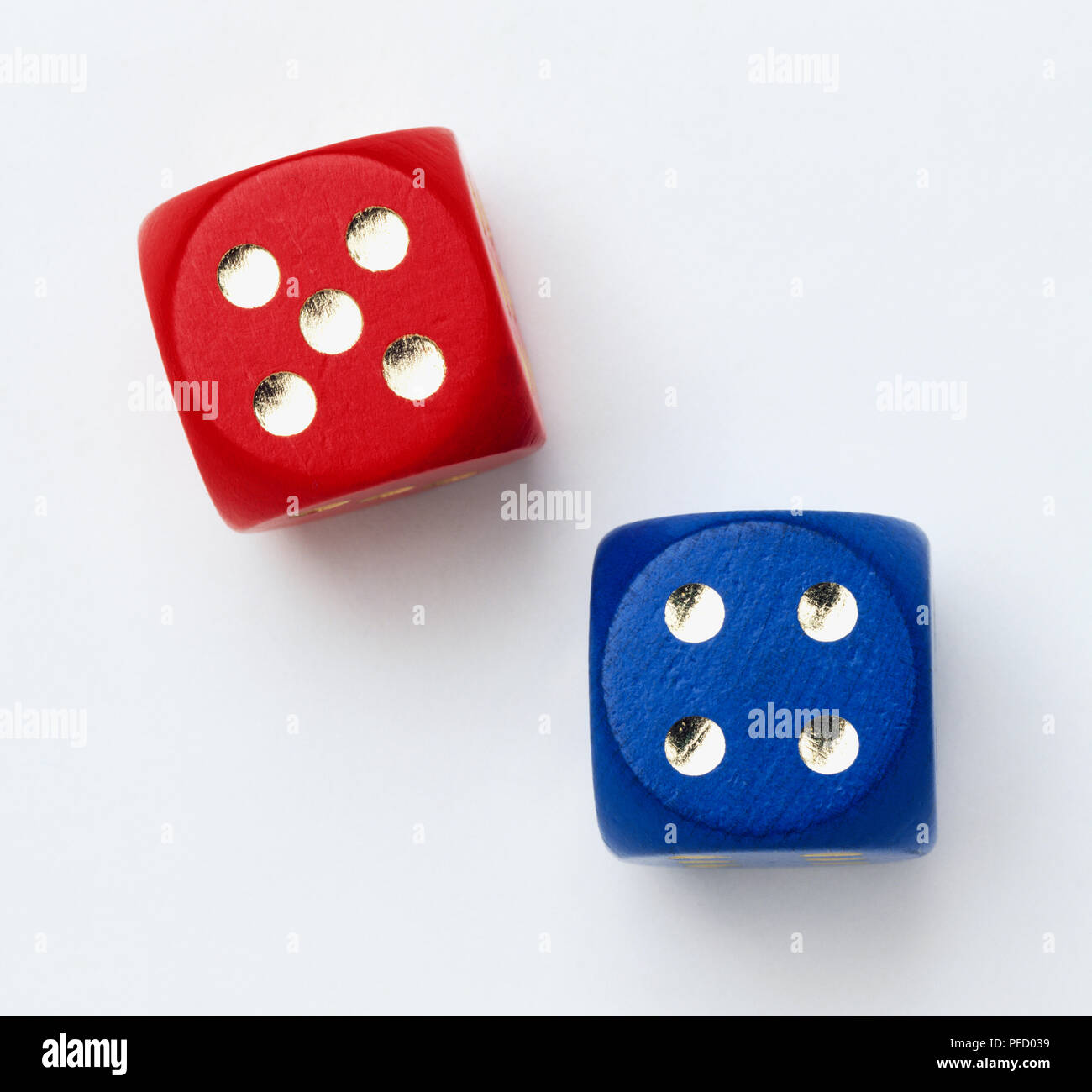 Red and blue dice with gold dots, close up. Stock Photo