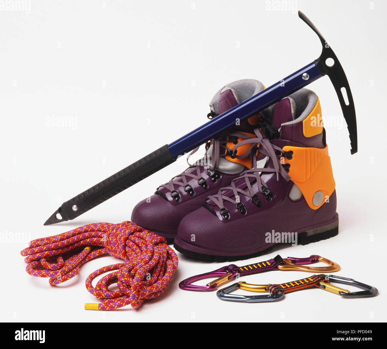 Mountaineering shoes, climbing blade, coiled rope, metal rope buckles