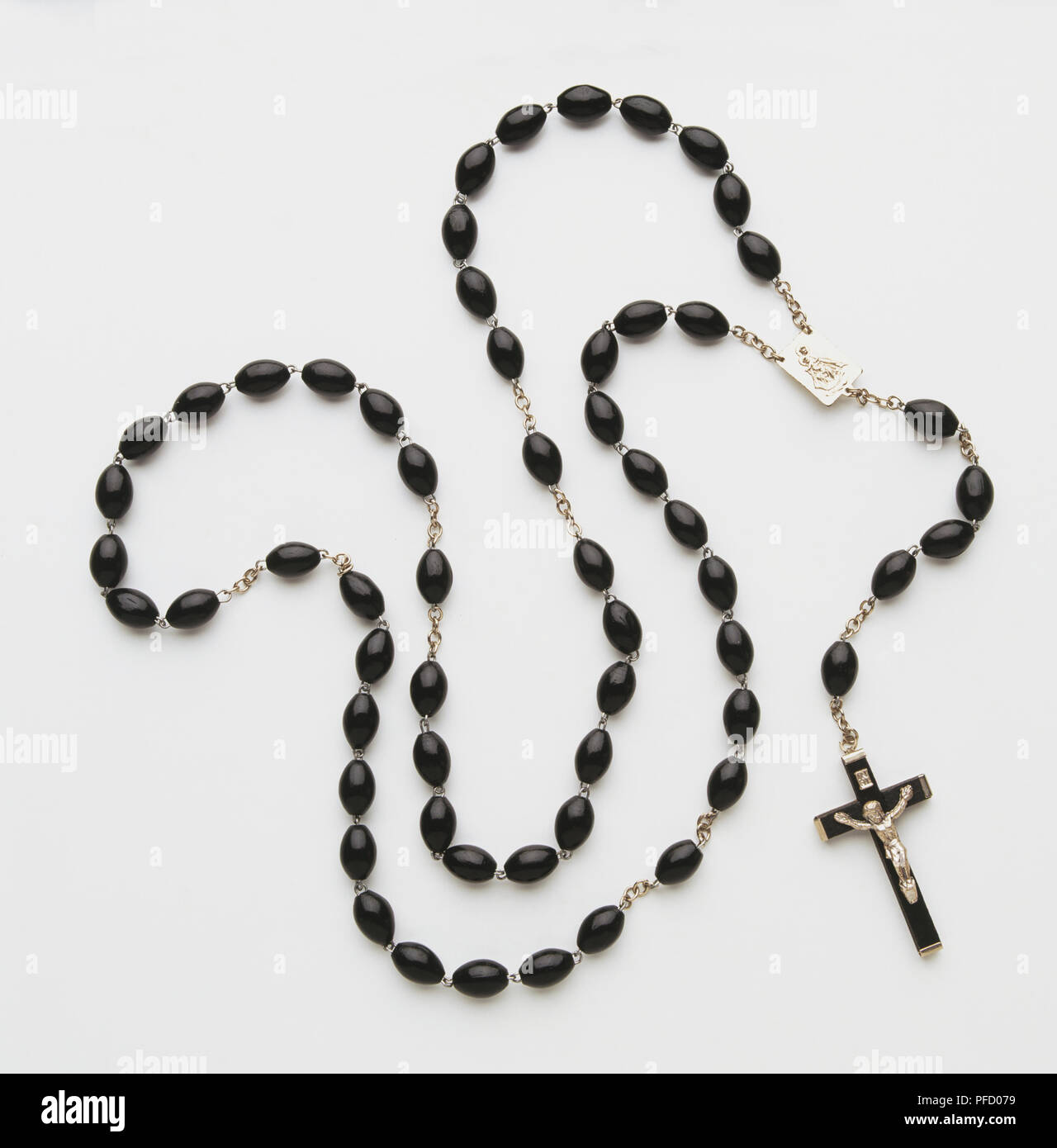 Small crucifix on sacred beads necklace, close up Stock Photo