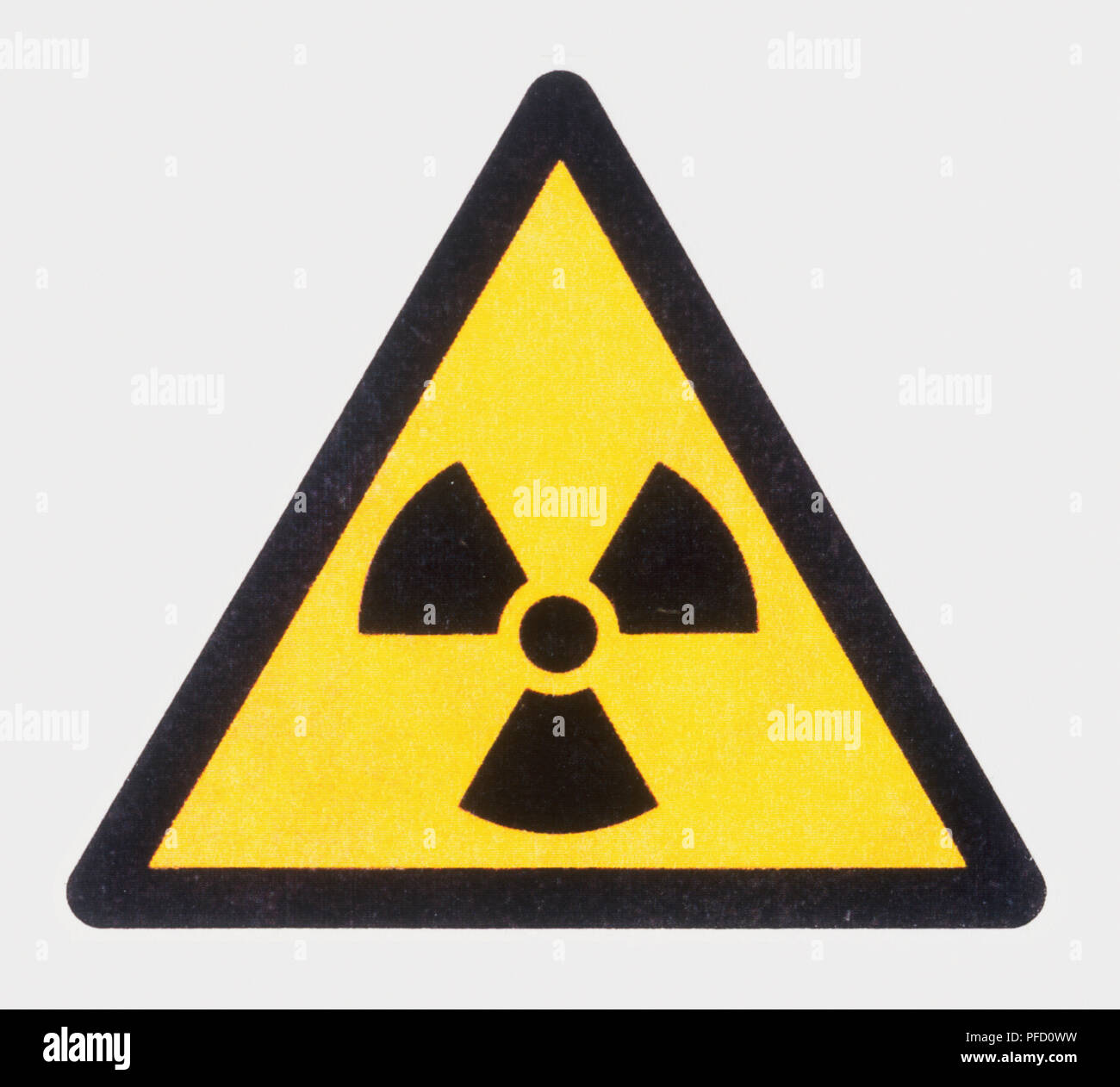 The radioactive material symbol on a yellow triangular sign Stock Photo