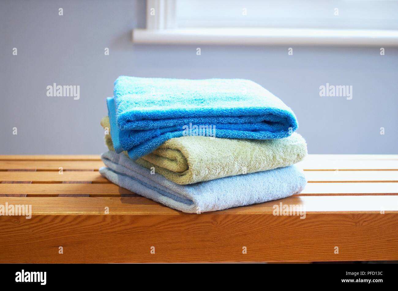 Pile of towels on bench Stock Photo Alamy