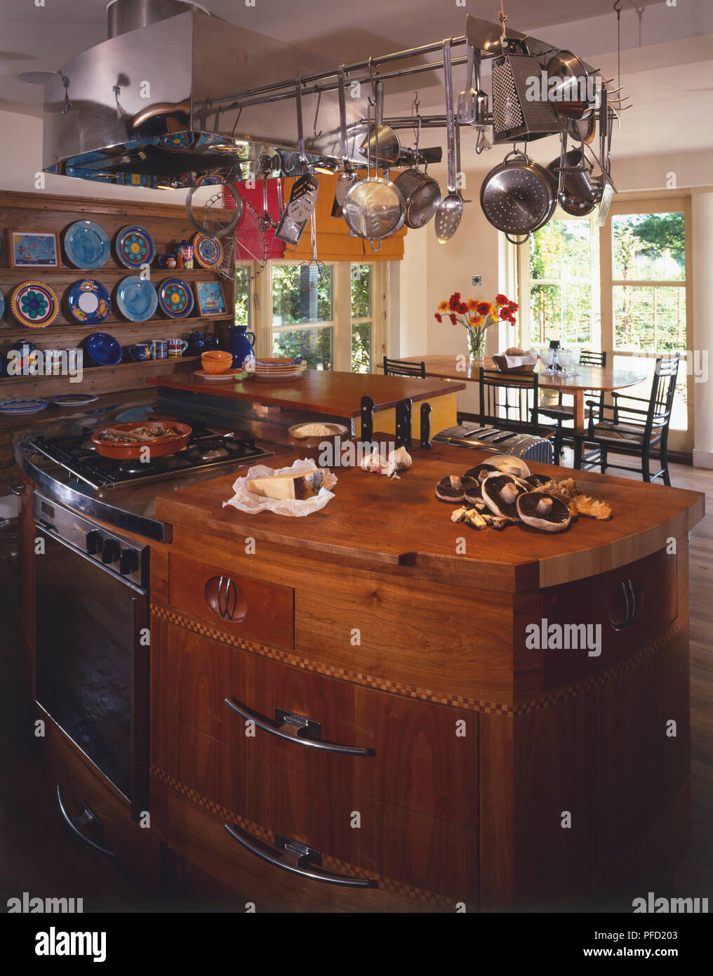 Cooking area in kitchen positioned centrally, facing dining area Stock