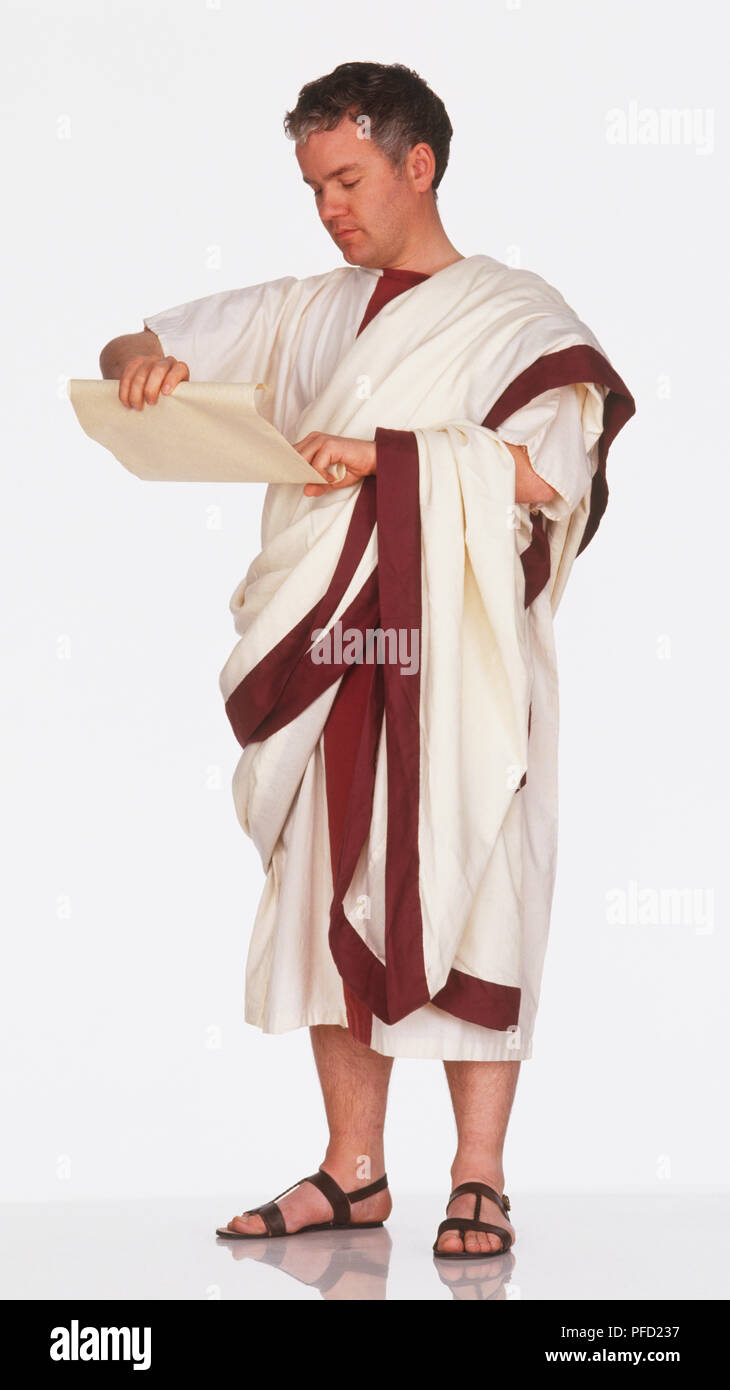 Man in Roman toga reading parchment Stock Photo