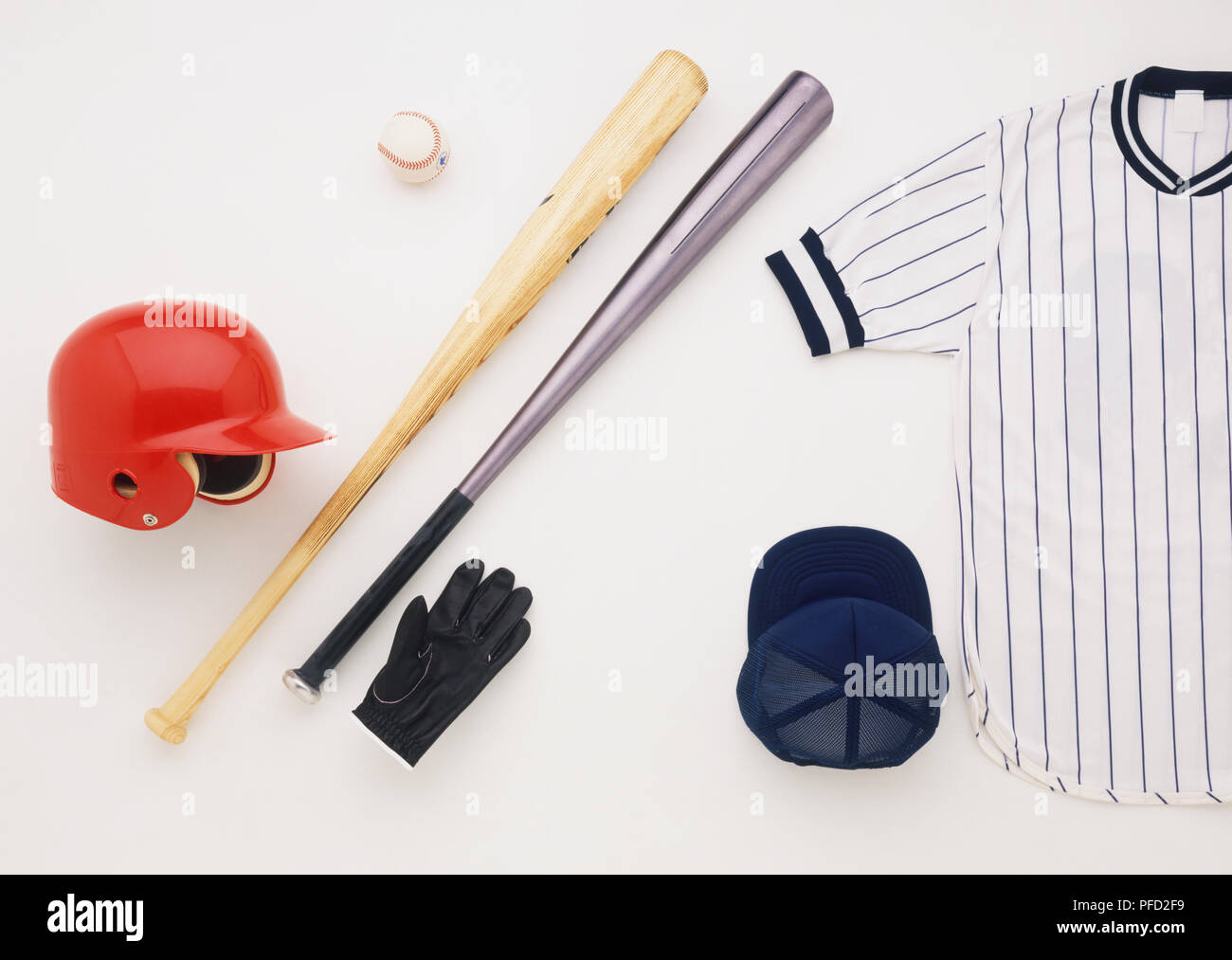 Baseball uniform and equipment, including bats, ball, helmet, cap, balling glove and shirt. Stock Photo