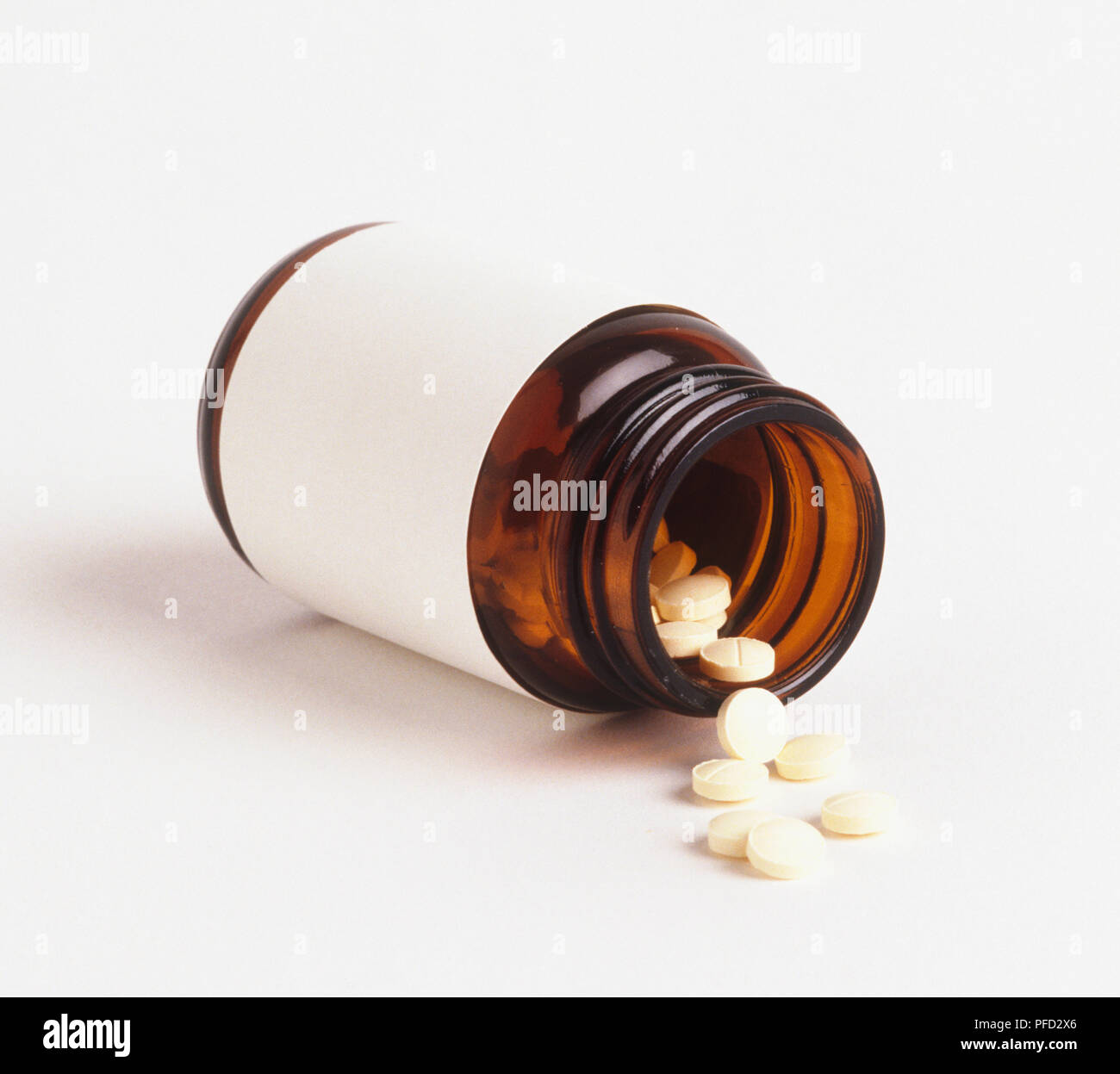 Pill bottle on its side, pills spilling out Stock Photo Alamy
