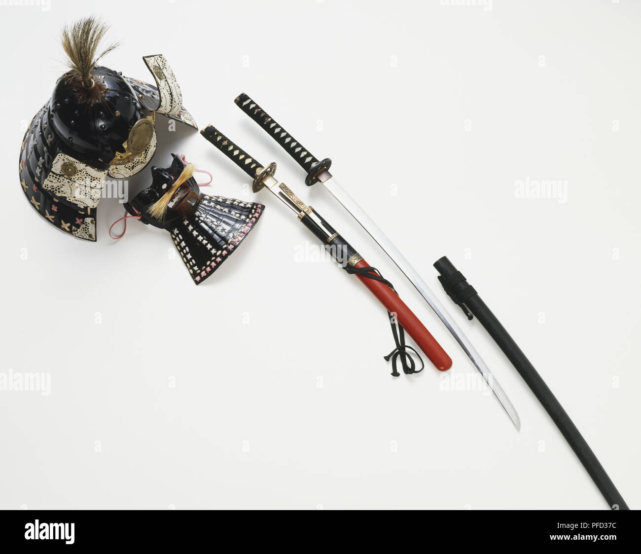 Collection of Samurai artefacts, including a helmet, mask, and a pair of swords Stock Photo