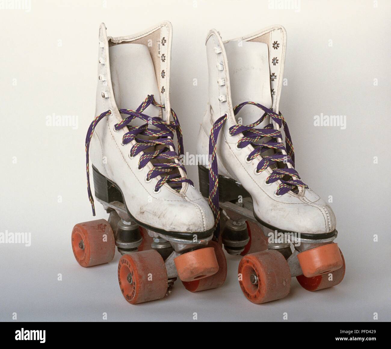 Pair of old, white roller skates Stock Photo - Alamy