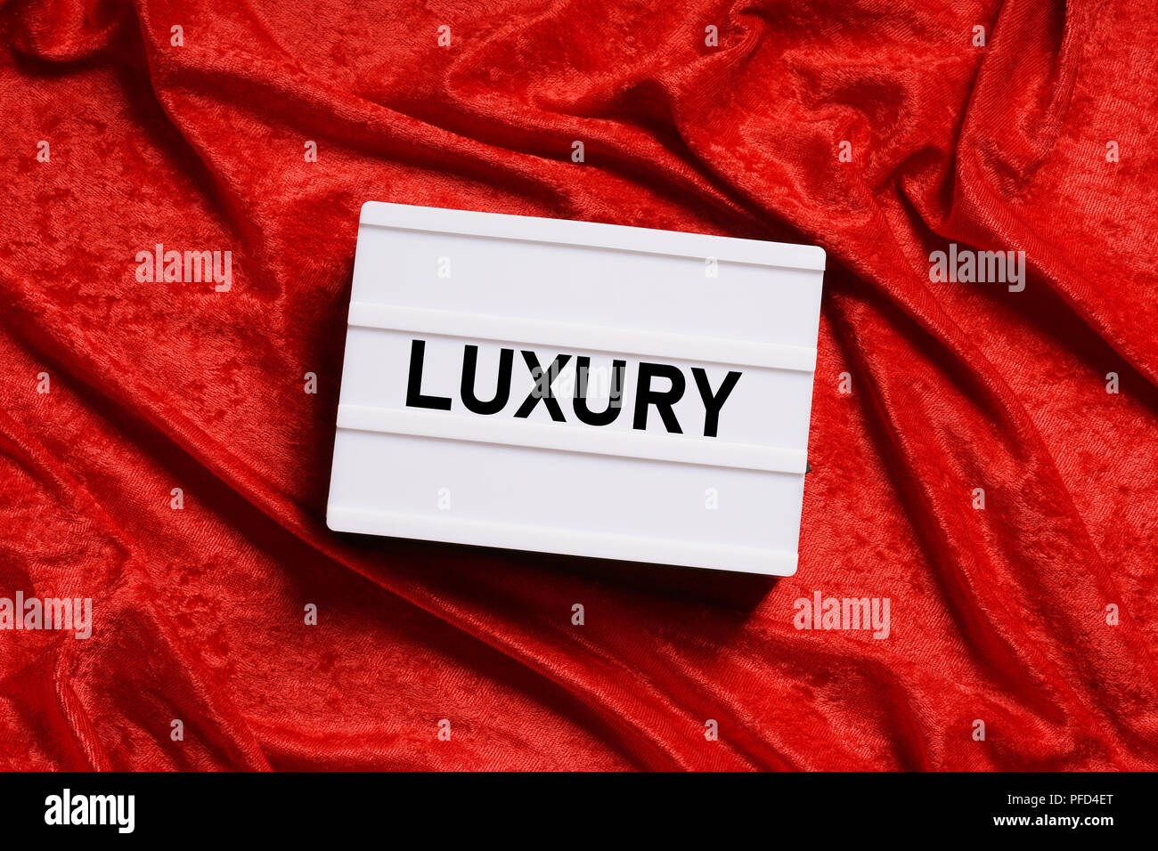 luxury text on lightbox or light box sign on red velvet background Stock Photo