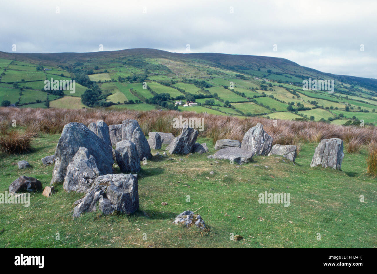 Ireland, Neolithic tomb and lush rolling landscape Stock Photo