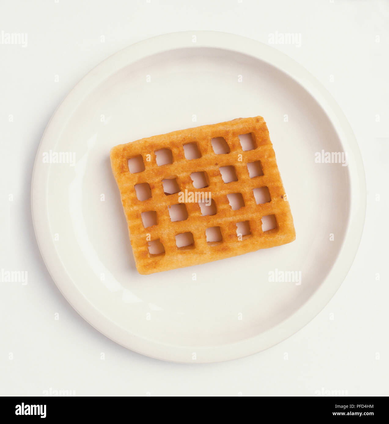 Waffle showing a pattern of square holes, served on a plate, view from above Stock Photo