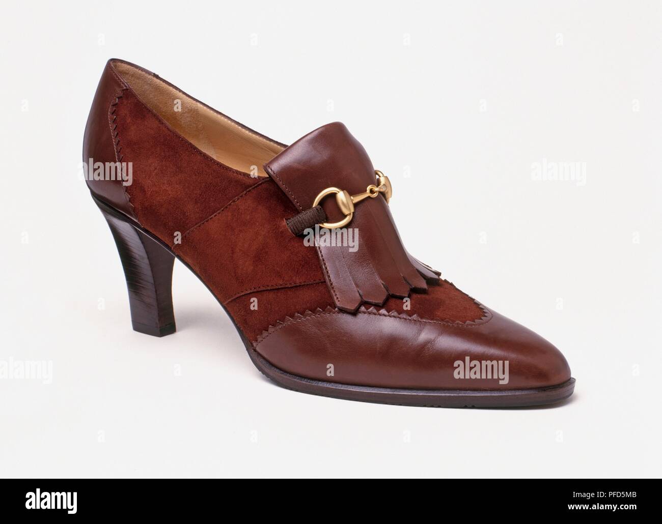 Brown leather highheeled shoe, made in Italy, closeup, side view