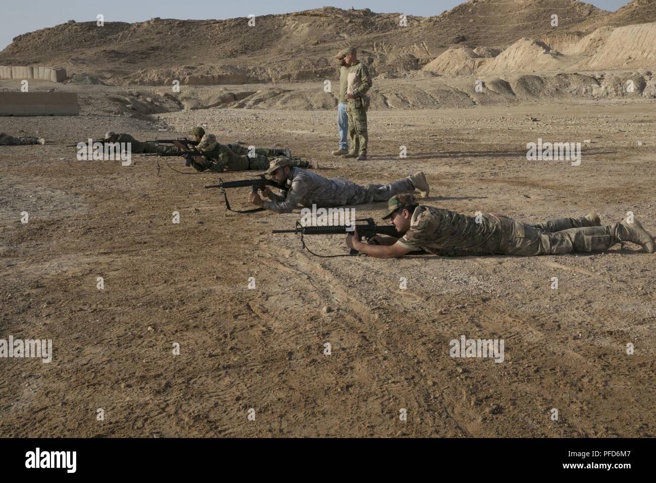 Border Guard Force members, assigned to 2nd Battalion, 4th Brigade, demonstrate how to bound forward during basic infantry drills at Al Asad Airbase, Iraq, June 4, 2018. Iraqi security forces are laying the foundation for the future of Iraq by improving their capabilities in order to provide a secure and stable environment for their nation. Stock Photo