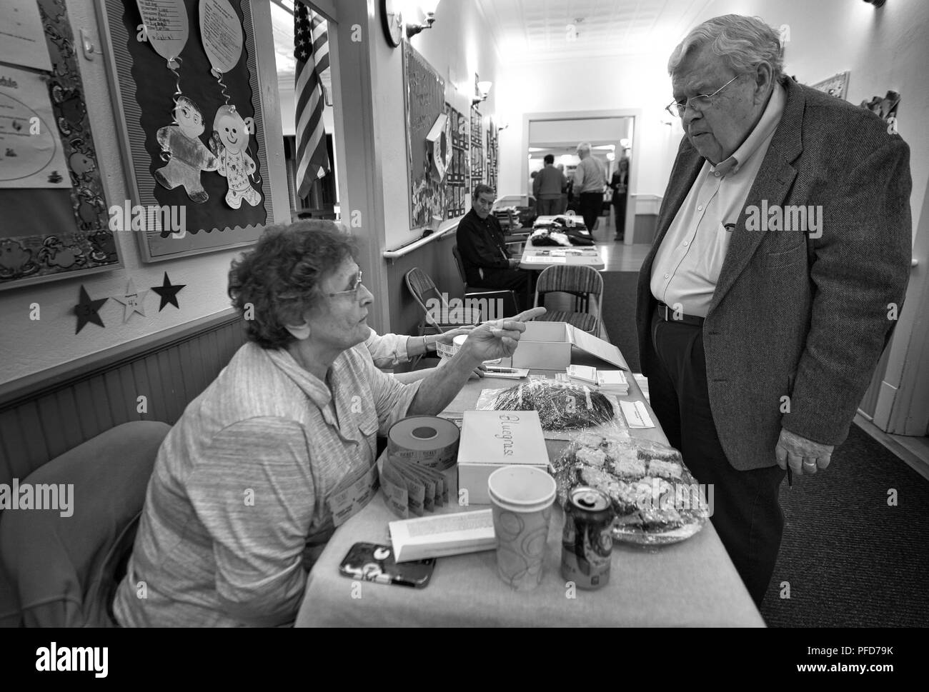 UNITED STATES - 02042017: Robert Veatch gets the low down on treats for sale before the bluegrass show starts from Nancy Mattia at the Lucketts school Stock Photo