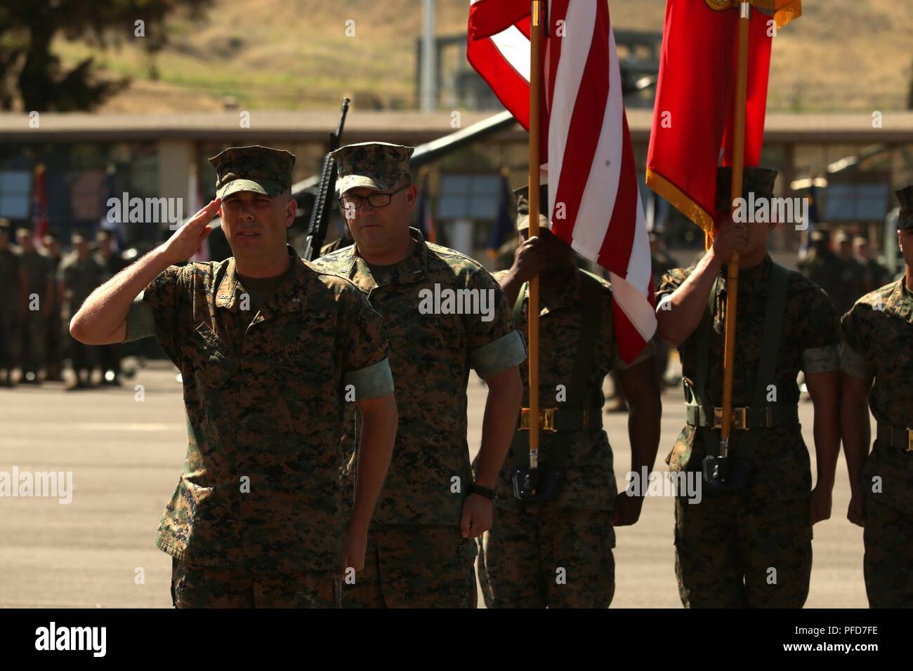 U.S. Marine Corps Chief Warrant Officer 5 David C. Thomas, center, with Fire and Maneuver Intergration Division, Headquarters Marine Corps, stands at attention during a retirement ceremony at Marine Corps Base Camp Pendleton, Calif., June 7, 2018. The ceremony was held in honor of Thomas for his 30 years of meritorious service. Stock Photo