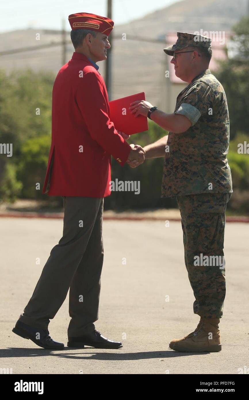 Retired U.S. Marine Corps Col. Michael Frasier, left, shakes the hand of Chief Warrant Officer 5 David C. Thomas with Fire and Maneuver Intergration Division, Headquarters Marine Corps, during a retirement ceremony at Marine Corps Base Camp Pendleton, Calif., June 7, 2018. The ceremony was held in honor of Thomas for his 30 years of meritorious service. Stock Photo
