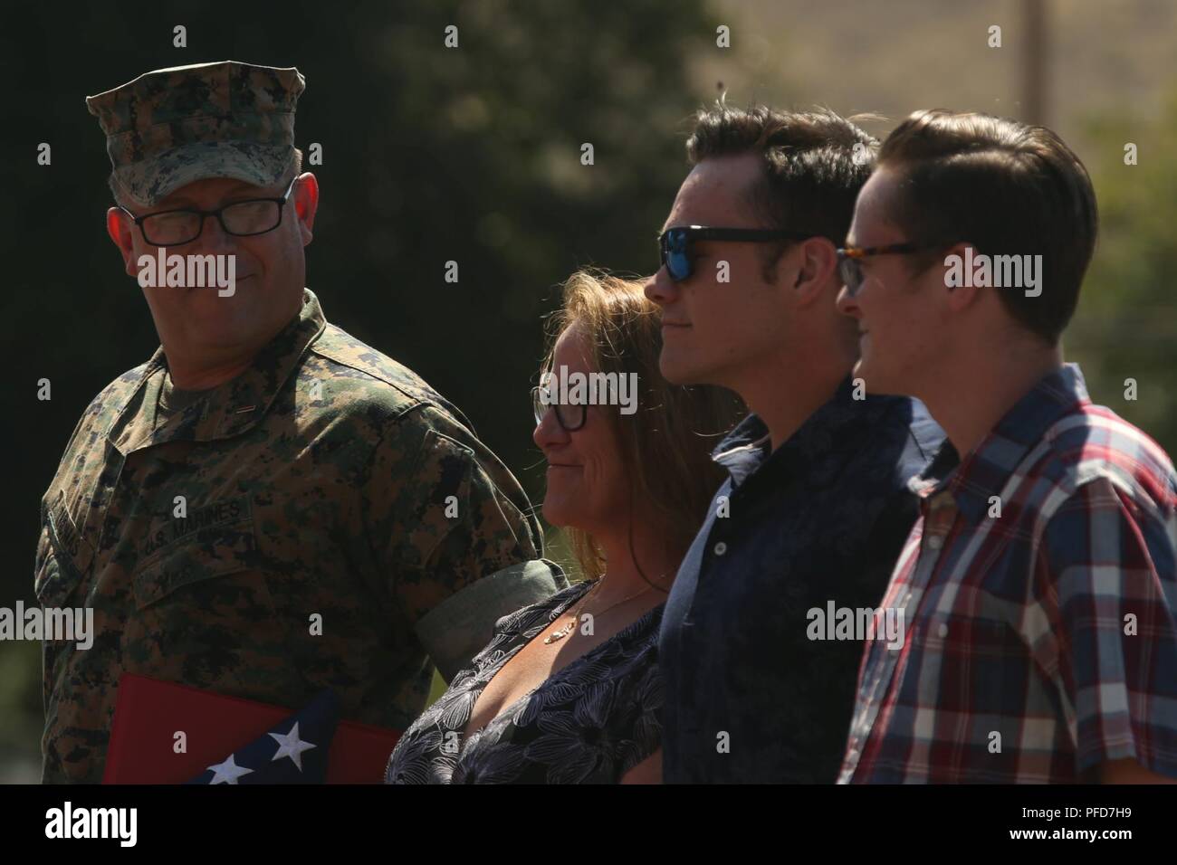 U.S. Marine Corps Chief Warrant Officer 5 David C. Thomas, left, with Fire and Maneuver Intergration Division, Headquarters Marine Corps, looks at his family during a retirement ceremony at Marine Corps Base Camp Pendleton, Calif., June 7, 2018. The ceremony was held in honor of Thomas for his 30 years of meritorious service. Stock Photo