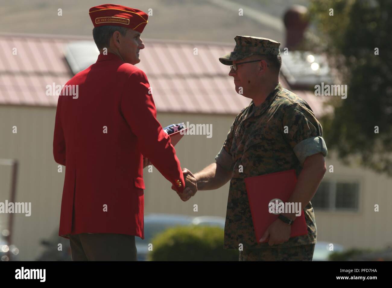 Retired U.S. Marine Corps Col. Michael Frasier, left, shakes the hand of Chief Warrant Officer 5 David C. Thomas with Fire and Maneuver Intergration Division, Headquarters Marine Corps, during a retirement ceremony at Marine Corps Base Camp Pendleton, Calif., June 7, 2018. The ceremony was held in honor of Thomas for his 30 years of meritorious service. Stock Photo