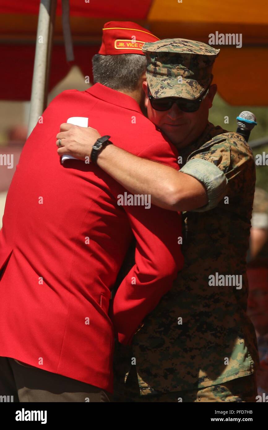 Retired U.S. Marine Corps Col. Michael Frasier, left, hugs Chief Warrant Officer 5 David C. Thomas with Fire and Maneuver Intergration Division, Headquarters Marine Corps, during a retirement ceremony at Marine Corps Base Camp Pendleton, Calif., June 7, 2018. The ceremony was held in honor of Thomas for his 30 years of meritorious service. Stock Photo
