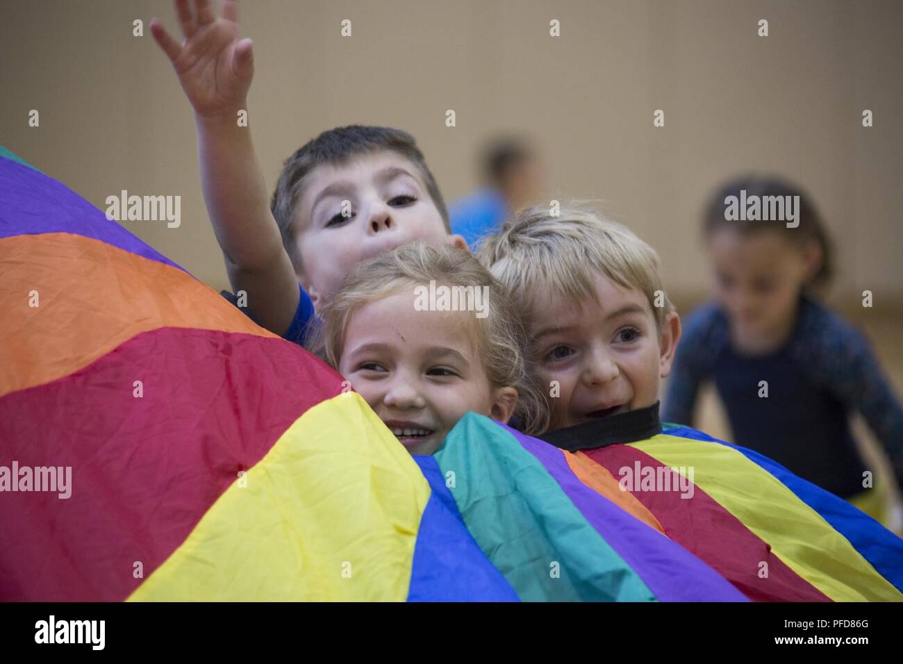 Students with Matthew C. Perry Elementary School play in a parachute during an end-of-year Field Day at Marine Corps Air Station Iwakuni, Japan, June 8, 2018. Field Day was organized in order to motivate students to stay active during the summer. Stock Photo