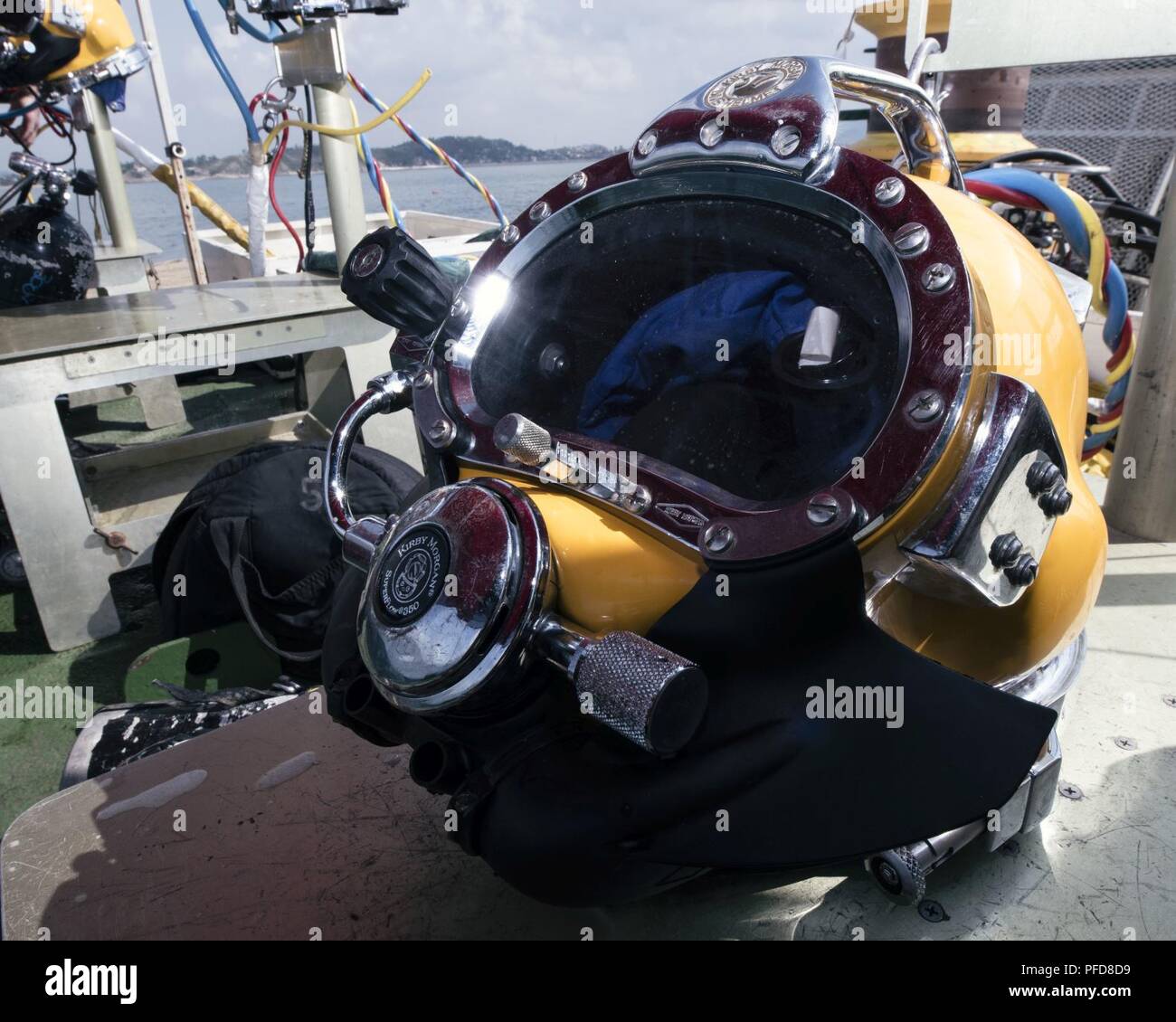 A KM-37 dive helmet sits on a dive bench during underwater recovery operations conducted by the Defense POWMIA Accounting Agency (DPAA) off the coast of Hoang Mai, Vietnam, June 2, 2018. The Defense POW/MIA Accounting Agency conducts global search, recovery and laboratory operations to provide the fullest possible accounting for our missing personnel to their families and the nation. Stock Photo