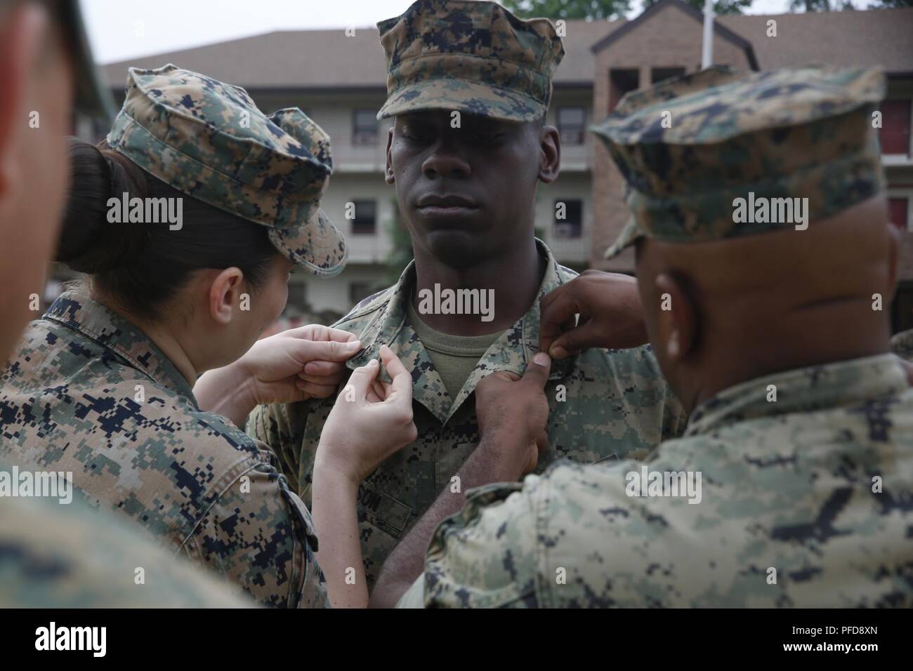 Beaufort, N.C.-native Jonathan Wilson, a motor vehicle operator with Motor Transport Platoon, Headquarters and Service Company, Chemical Biological Incident Response Force, receives his new rank insignias during a promotion ceremony aboard Naval Support Facility Indian Head, Md., June 1, 2018. Wilson was promoted to the rank of sergeant during the ceremony. Stock Photo