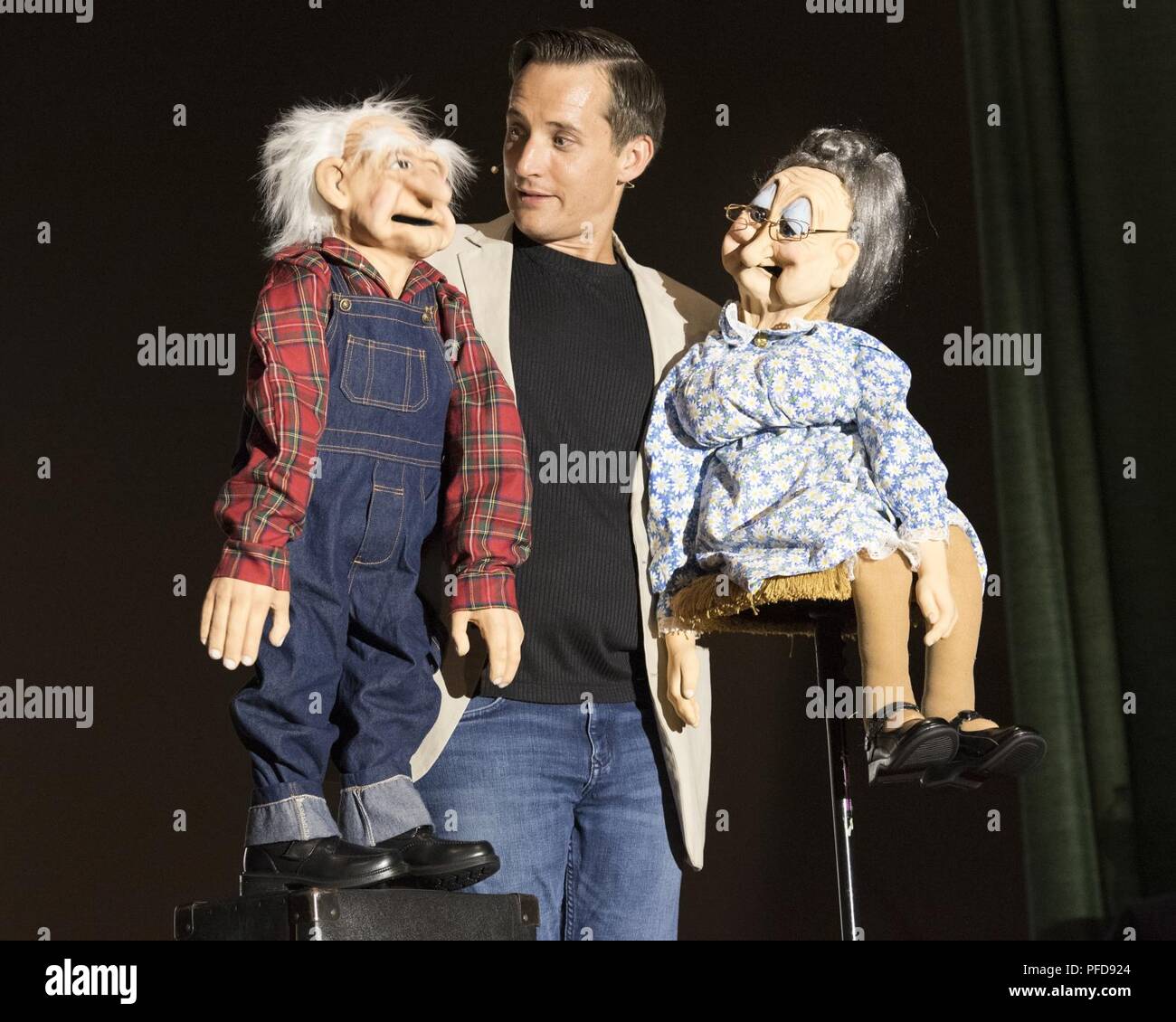 Comedian and ventriloquist entertainer, Ryan, performs on stage with