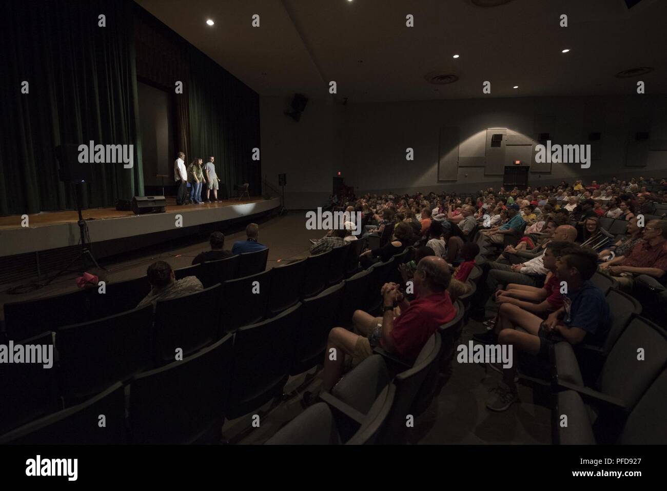 A crowd watches a performance by participants from the audience and