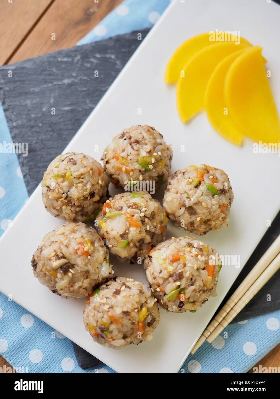 Asian food beef and vegetables rice balls and pickled radish Stock