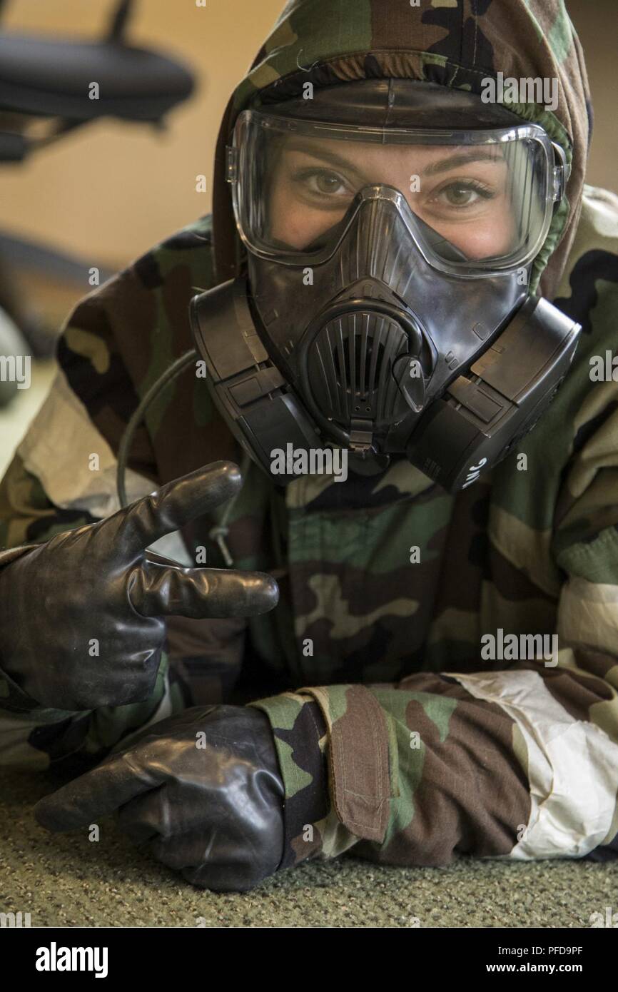 Airmen from the 179th Airlift Wing, Mansfield, Ohio, conduct Ability to Survive and Operate, or ATSO training course, June 5, 2018, held at the Alpena Combat Readiness Traning Center, Alpena, Michigan. The Airmen don Mission Oriented Protective Posture (MOPP) protective gear used by U.S. military personnel in a toxic environment during a chemical, biological, radiological, or nuclear (CBRN) strike. Rotating through stations, Airmen train how to correctly put on MOPP gear and help others put it on, medical Self-Aid Buddy Care, correct decontamination procedures and how to give a detailed report Stock Photo