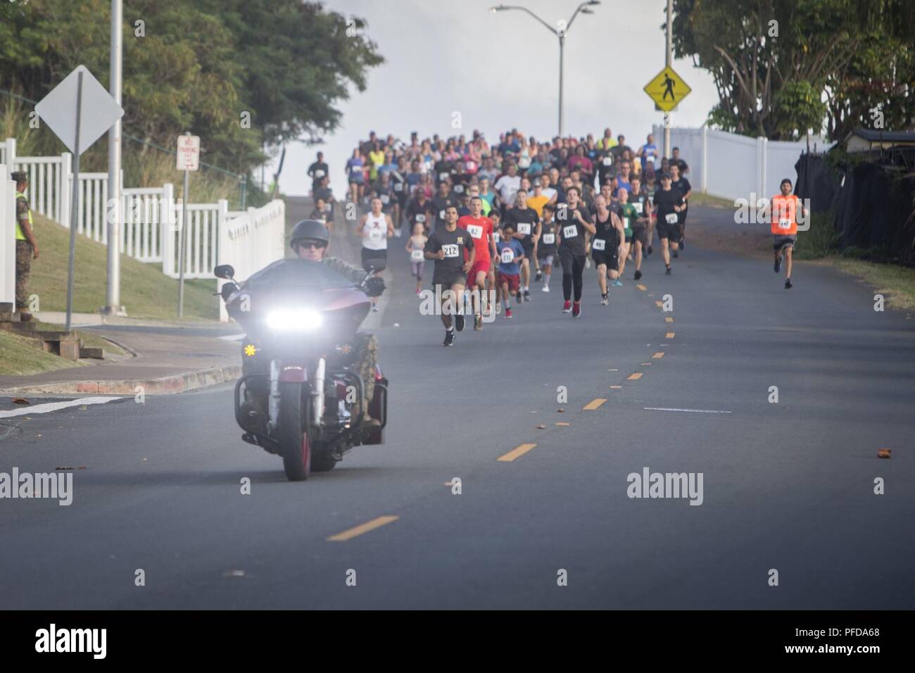 MARINE CORPS BASE HAWAII — Race participant Petty Officer 3rd Class Jessica  Treu crosses the finish line during the 12th annual Splash \u0026 Dash Biathlon  aboard Marine Corps Base Hawaii, Oct. 3,, image size:1300x956