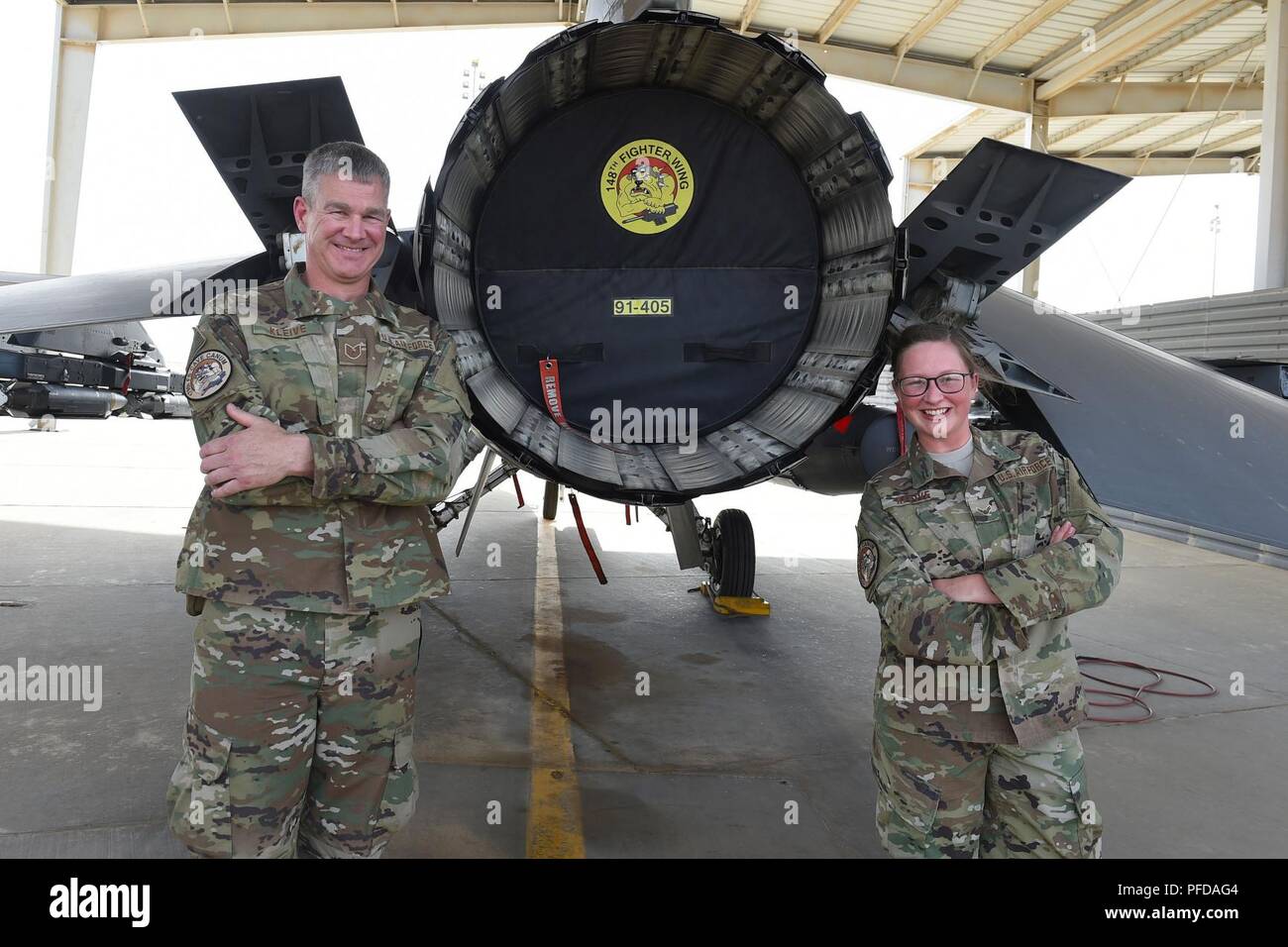 Tech. Sgt. Scott Kleive (left), and his daughter, Airman 1st Class Kalei Kleive, pose for a photograph at an undisclosed location, June 9, 2018. Both are assigned to the 407th Air Expeditionary Group and deployed from the Air National Guard's 148th Fighter Wing in Duluth, Minnesota. Stock Photo