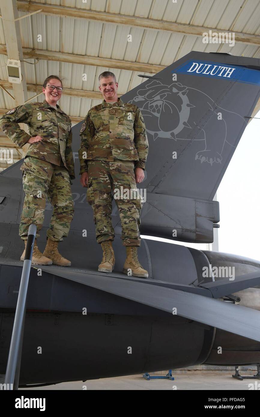 Airman 1st Class Kalei Kleive (left), and her father, Tech. Sgt. Scott Kleive, pose for a photograph at an undisclosed location, June 9, 2018. Both are assigned to the 407th Air Expeditionary Group and deployed from the Air National Guard's 148th Fighter Wing in Duluth, Minnesota. Stock Photo